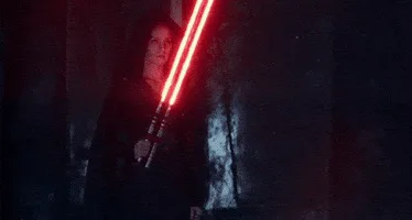 A six-panel image sequence shows Angela Bassett as Misty from Star Wars: The Force Awakens holding a red lightsaber that…
