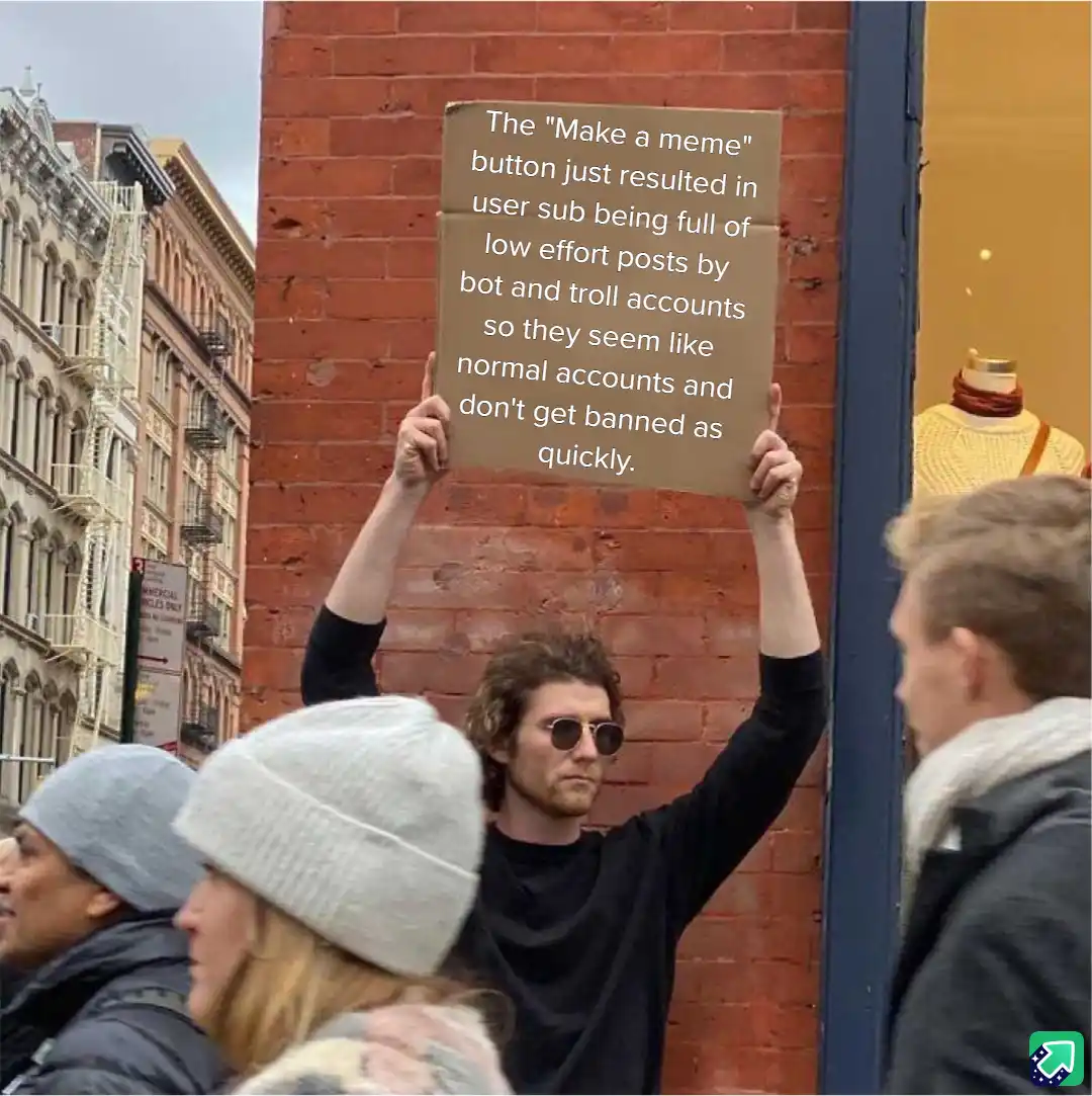 A man with curly hair and sunglasses holds up a cardboard sign in front of a brick wall, complaining about the 'Make a meme'…