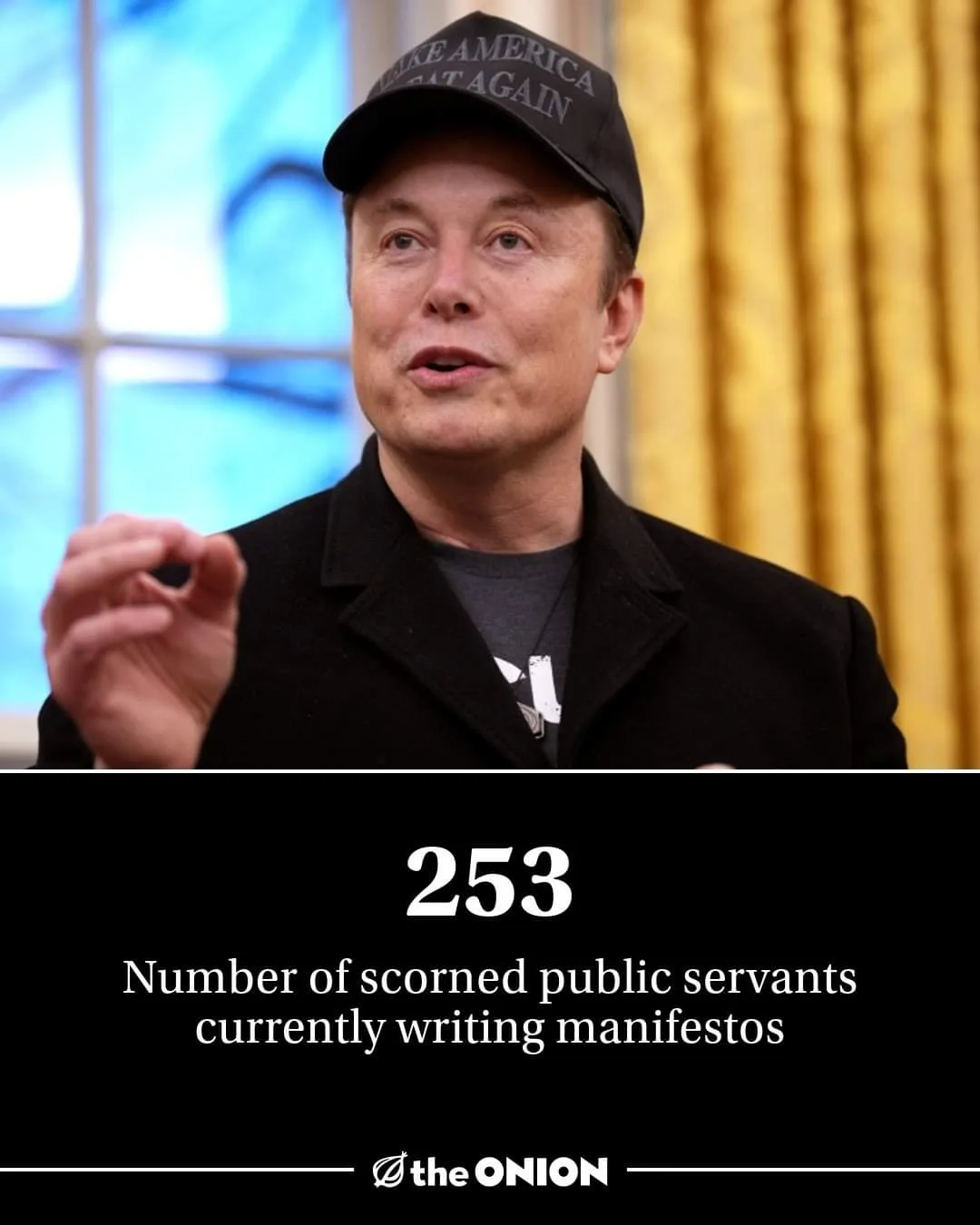 A man wearing a black 'Make America Great Again' cap and a black coat over a grey t-shirt is shown mid-speech, gesturing…