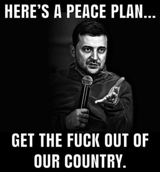 A black-and-white image of Ukrainian President Volodymyr Zelenskyy holding a microphone and gesturing with his other hand…