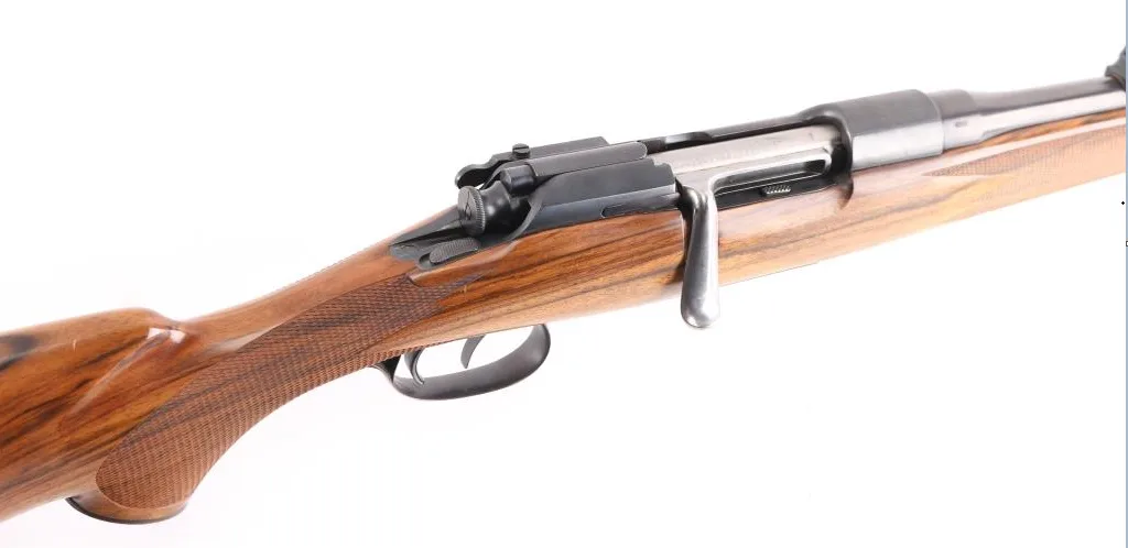 A close-up photo of a wooden-stocked bolt-action rifle against a white background, with the overlaid text 'i'm not a gun…