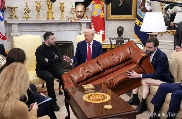 In a formal room resembling the Oval Office, a man in a dark suit sits on a brown leather couch while another man in a blue…