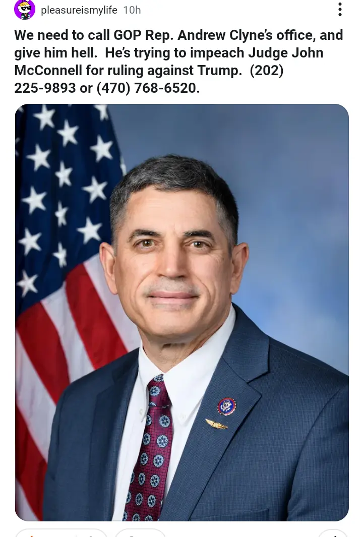 A formal headshot of a man in a dark suit and patterned tie, standing in front of an American flag. The overlaid text urges…