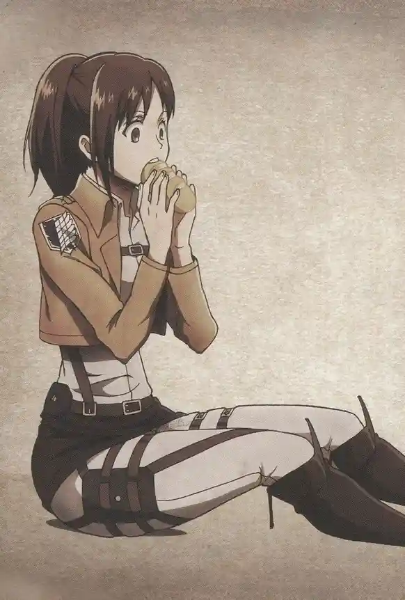 An anime girl in a brown uniform with a military-style insignia on her sleeve sits on the ground, eating a bread roll with…