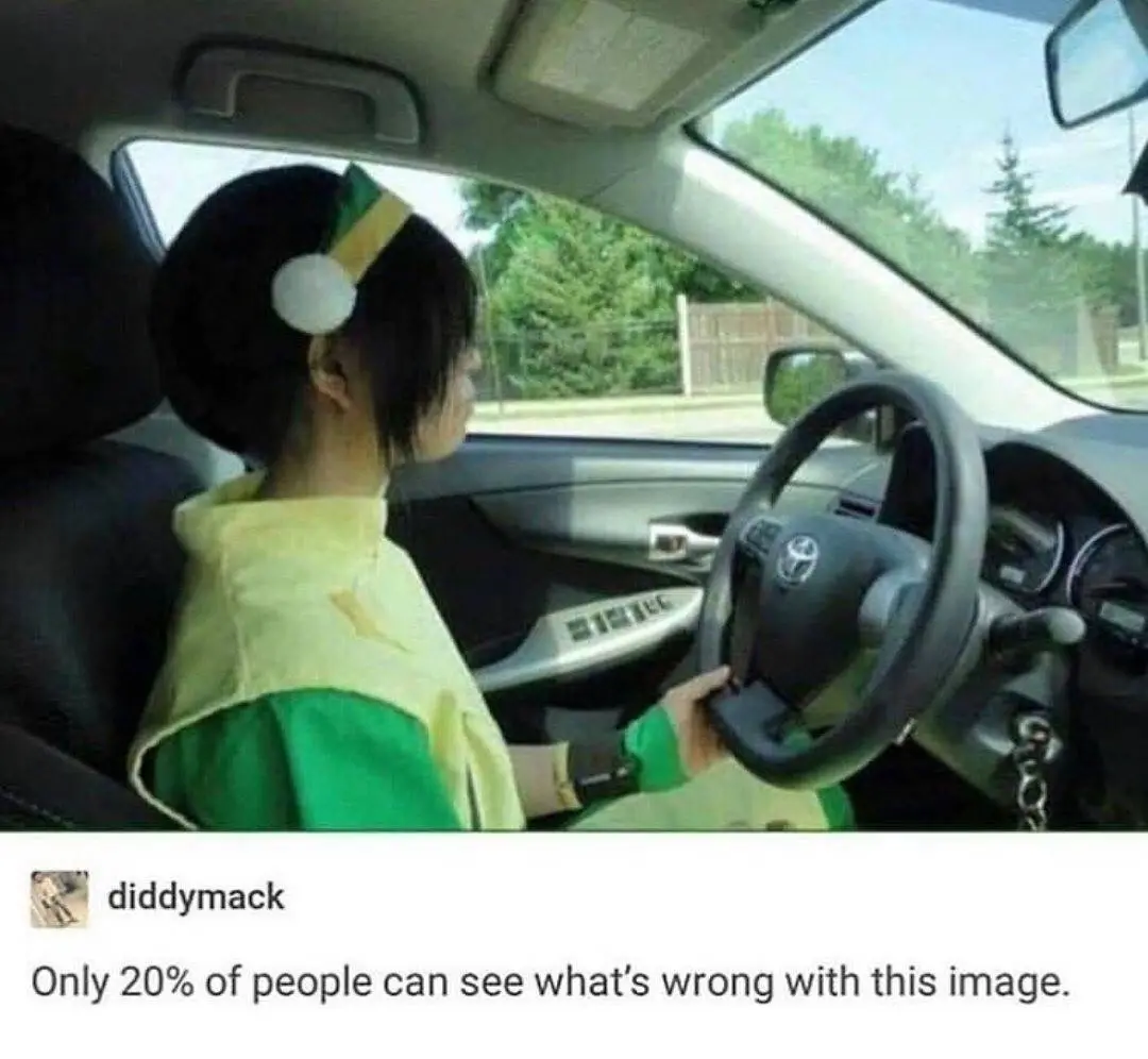 A person in a green and yellow cosplay outfit, resembling a character from a popular anime, is sitting in the driver's seat…