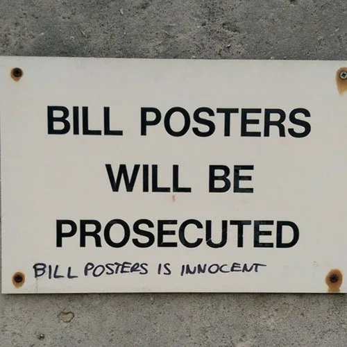 A white sign with black text warns that 'BILL POSTERS WILL BE PROSECUTED', but a handwritten note at the bottom says 'BILL…