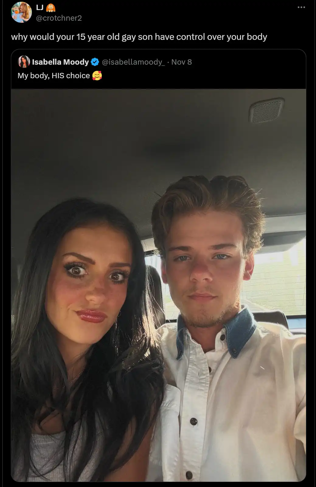 A selfie of a woman and a young man sitting in a car, with overlaid text showing a Twitter thread where one user asks why a…