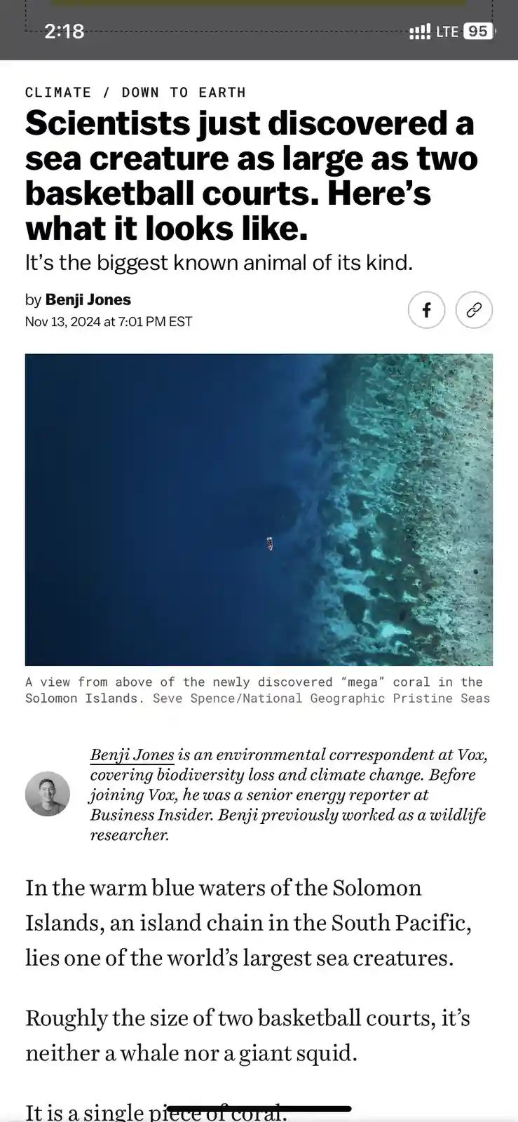 An article screenshot from Vox shows a large, flat, coral reef structure underwater, with a small boat visible for scale…