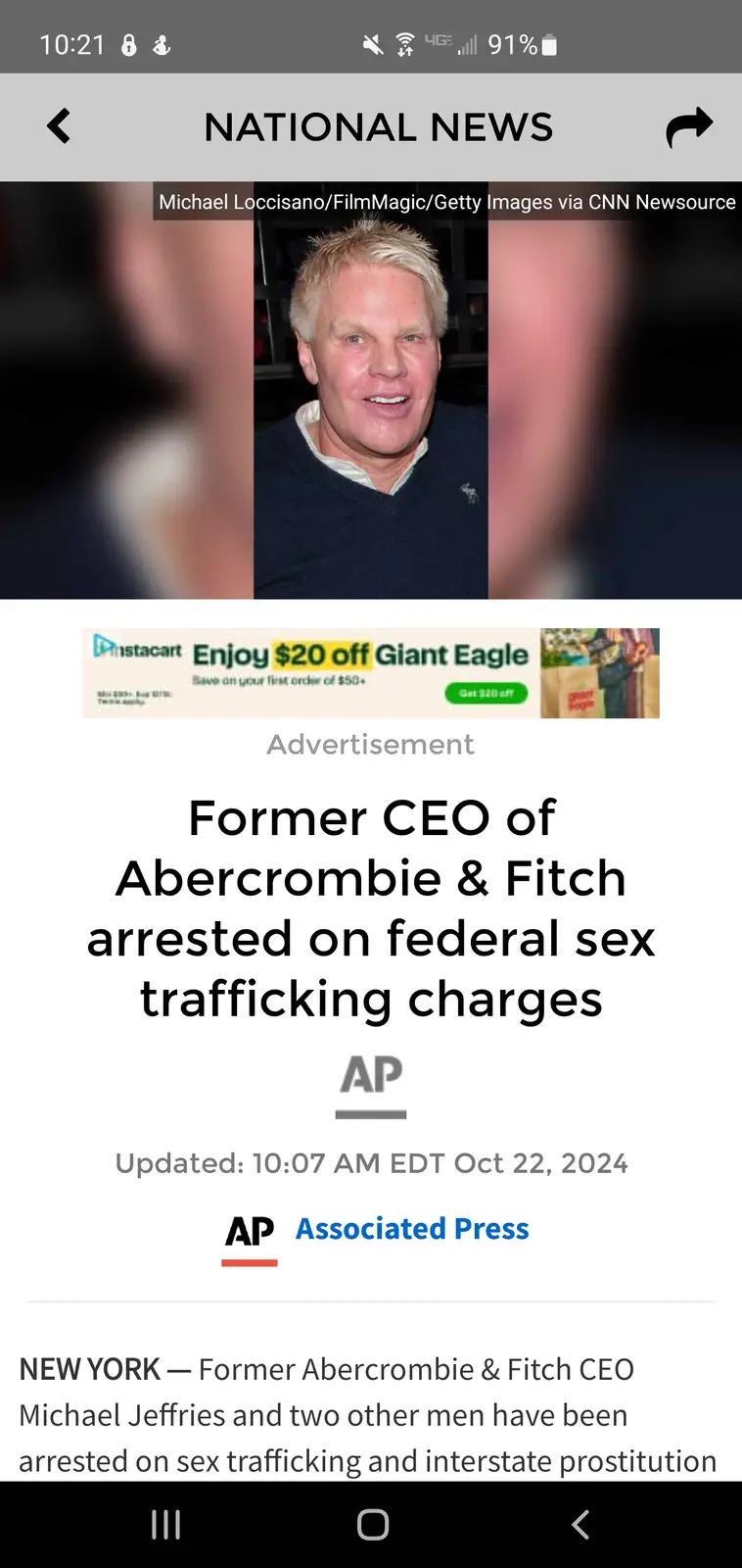 A screenshot of a news article from a mobile phone showing a photo of Michael Jeffries, former CEO of Abercrombie & Fitch…