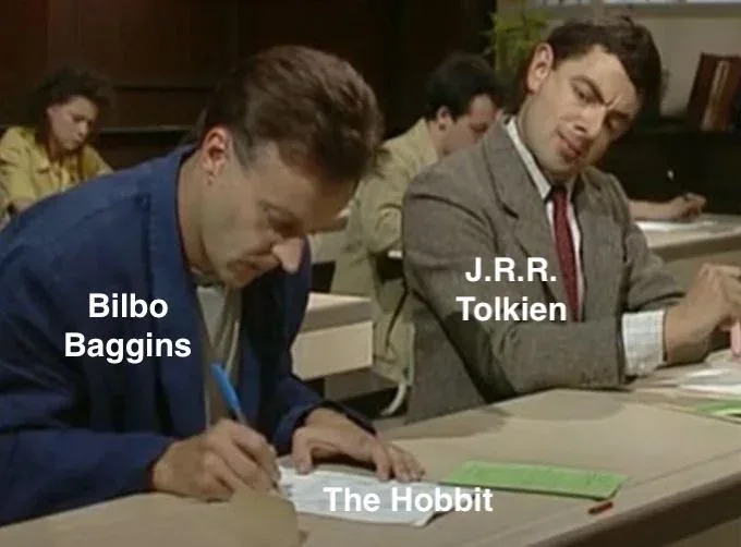 Two men sit at a desk in a classroom setting, one writing intently while the other looks on with a skeptical expression…