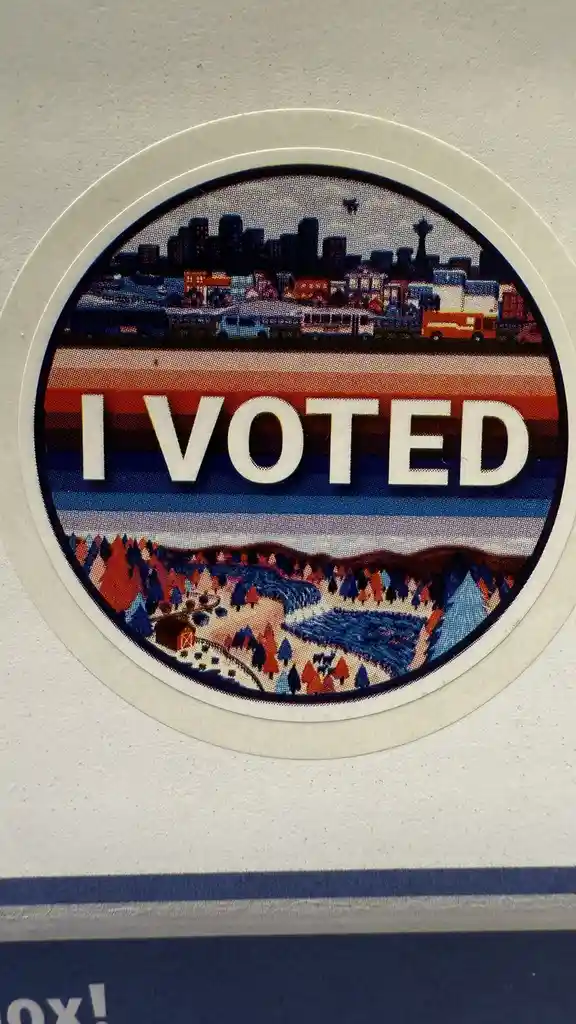 A circular 'I VOTED' sticker features a stylized illustration of a city skyline with a prominent space needle, a highway…