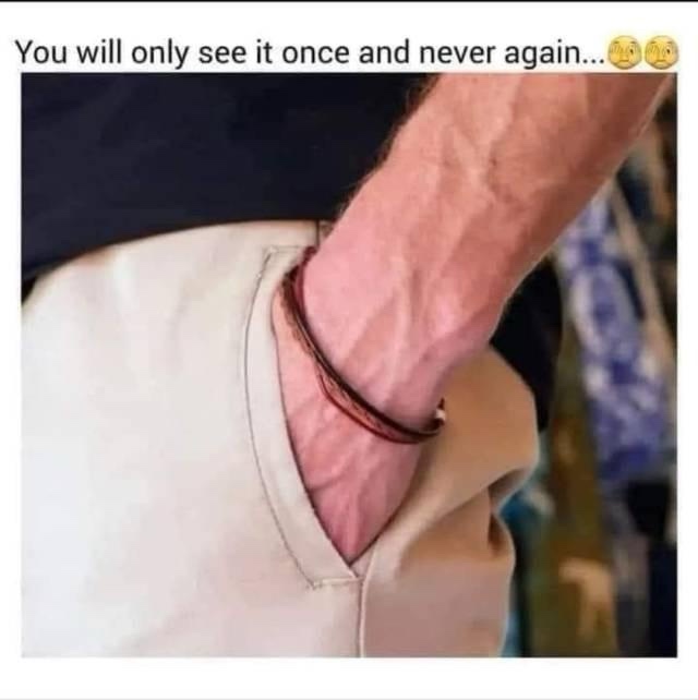 A close-up photo shows a person's arm and hand, with a dark leather bracelet, partially inserted into the pocket of…