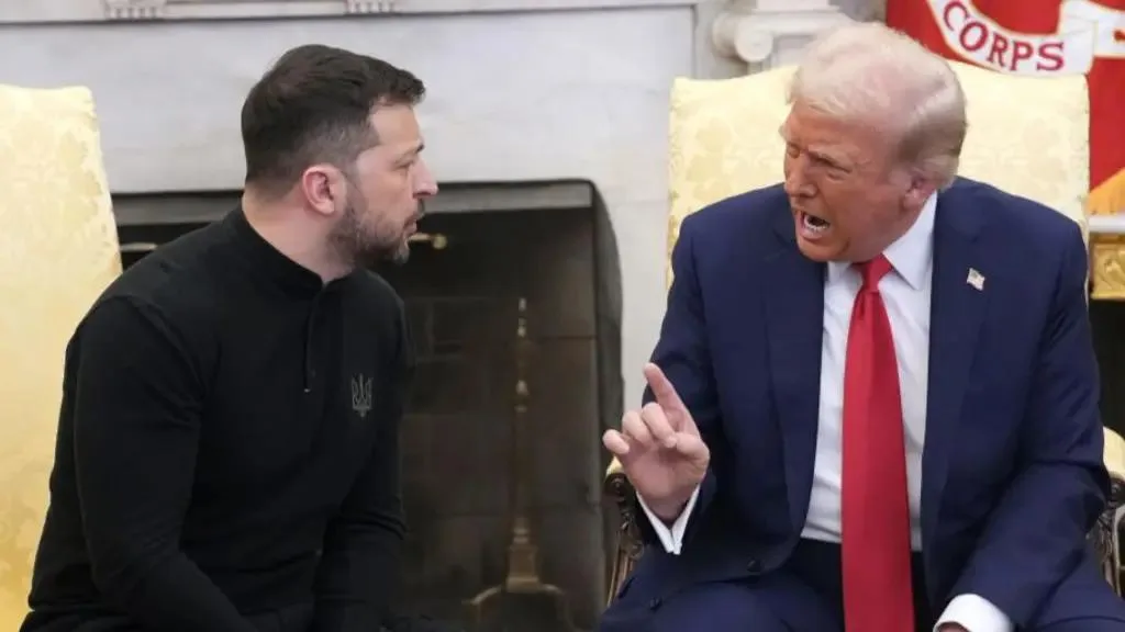 A photo shows Donald Trump, in a blue suit and red tie, yelling and pointing his finger at Volodymyr Zelenskyy, who is…