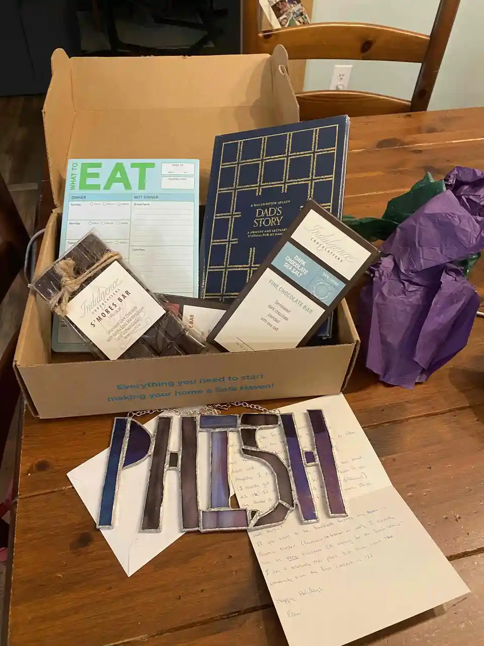 A cardboard box labeled 'Everything you need to start making your home a Safe Haven!' contains items like a 'What to Eat'…