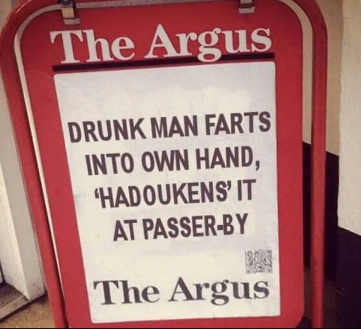 A red newspaper stand sign for 'The Argus' displays a headline about a drunk man farting into his own hand and then…