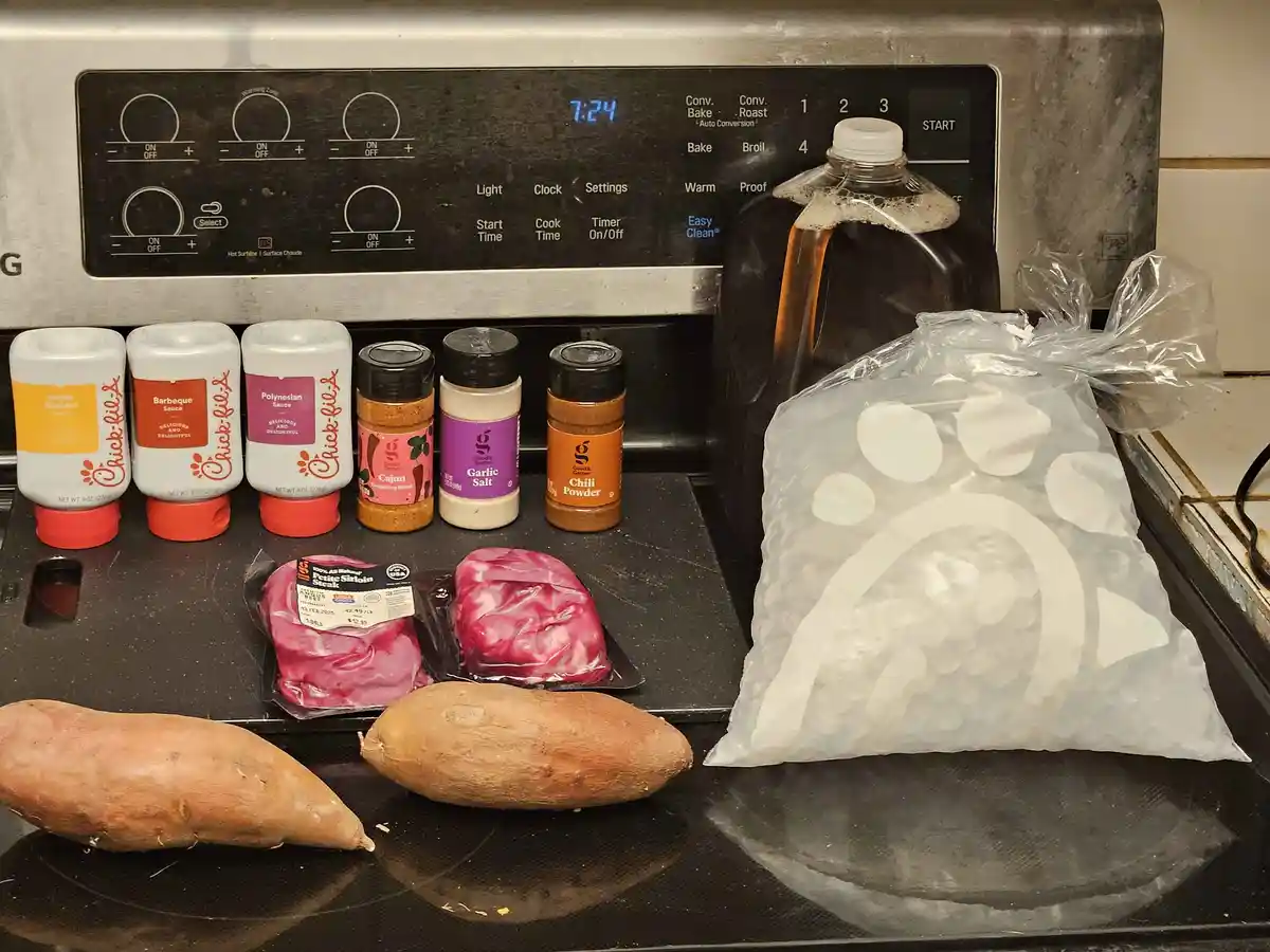 An electric stove top displays a collection of cooking ingredients including three Chick-fil-A sauces, three spice jars, two…
