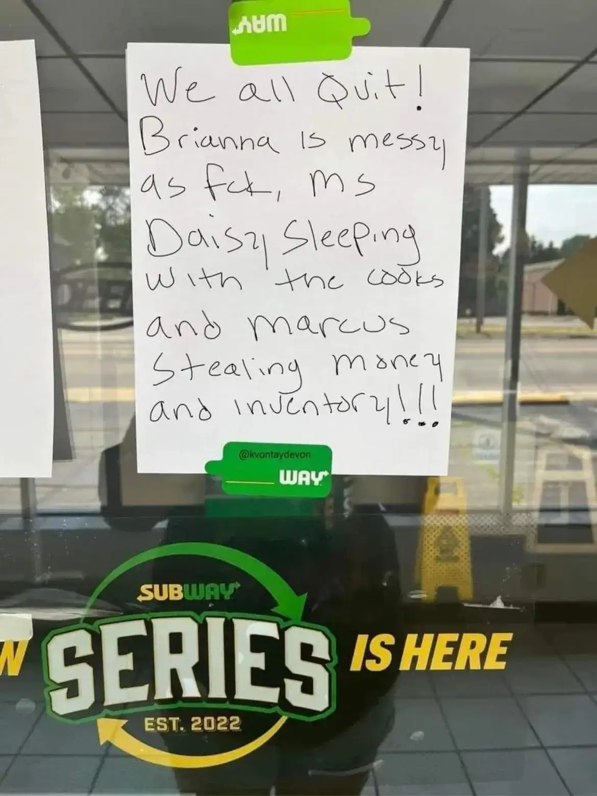 A handwritten note taped to a Subway restaurant window lists grievances about coworkers, including being messy, sleeping…