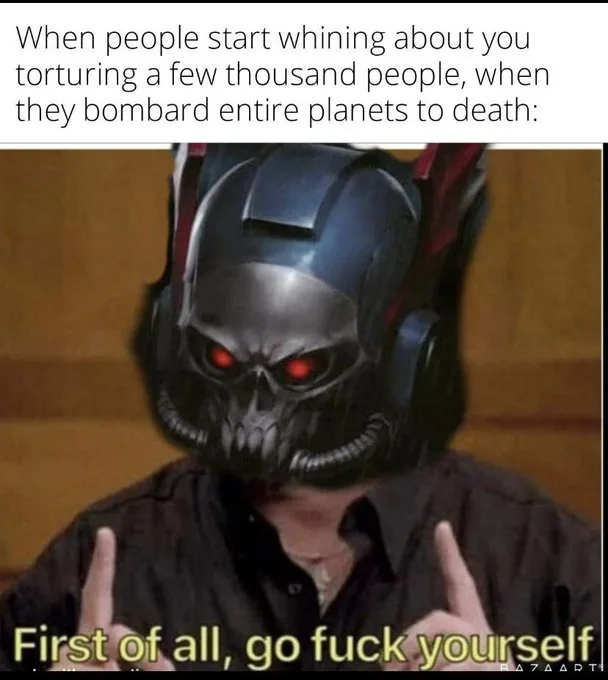 A person wearing a black and red skull helmet with glowing red eyes, making a dismissive gesture with both index fingers…
