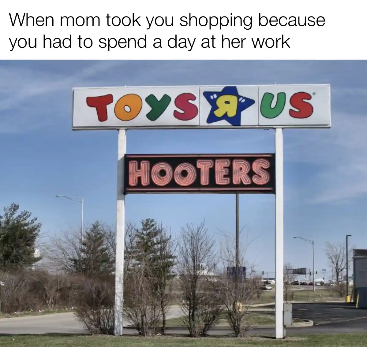 An outdoor photo shows a large sign with 'TOYS R US' in colorful letters on top and 'HOOTERS' in red neon letters below…