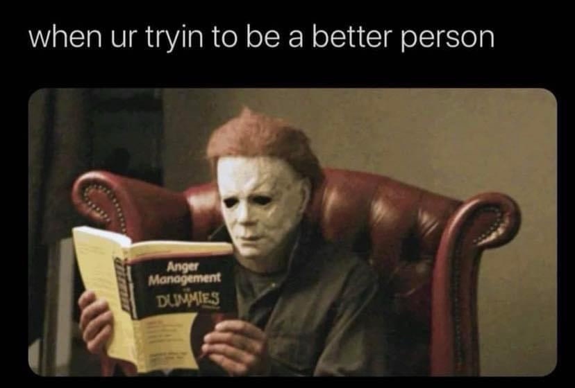 A person wearing a white Michael Myers mask sits in a red leather armchair, holding and reading a book titled 'Anger…