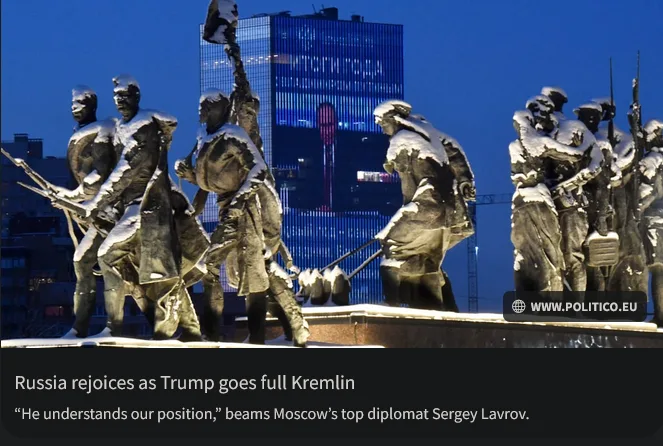 A snow-covered bronze monument depicting soldiers in combat poses, with a modern glass skyscraper visible in the background…
