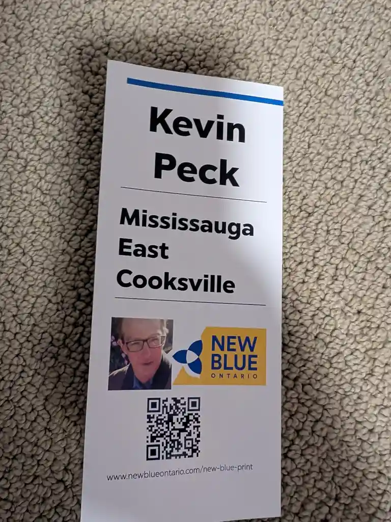 A white political campaign flyer for Kevin Peck, candidate for Mississauga East Cooksville under the New Blue Ontario party…
