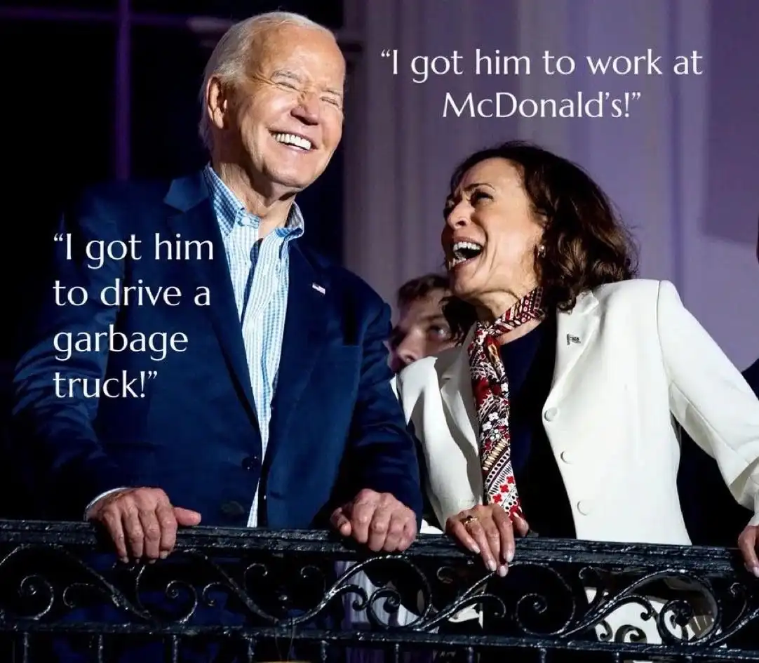 A photo of Joe Biden and Kamala Harris laughing together while leaning on a black metal railing. White text overlaid on the…