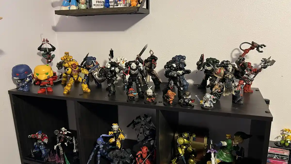 A dark wooden shelf holds numerous action figures of various sizes and styles, including armored warriors, robots, and…