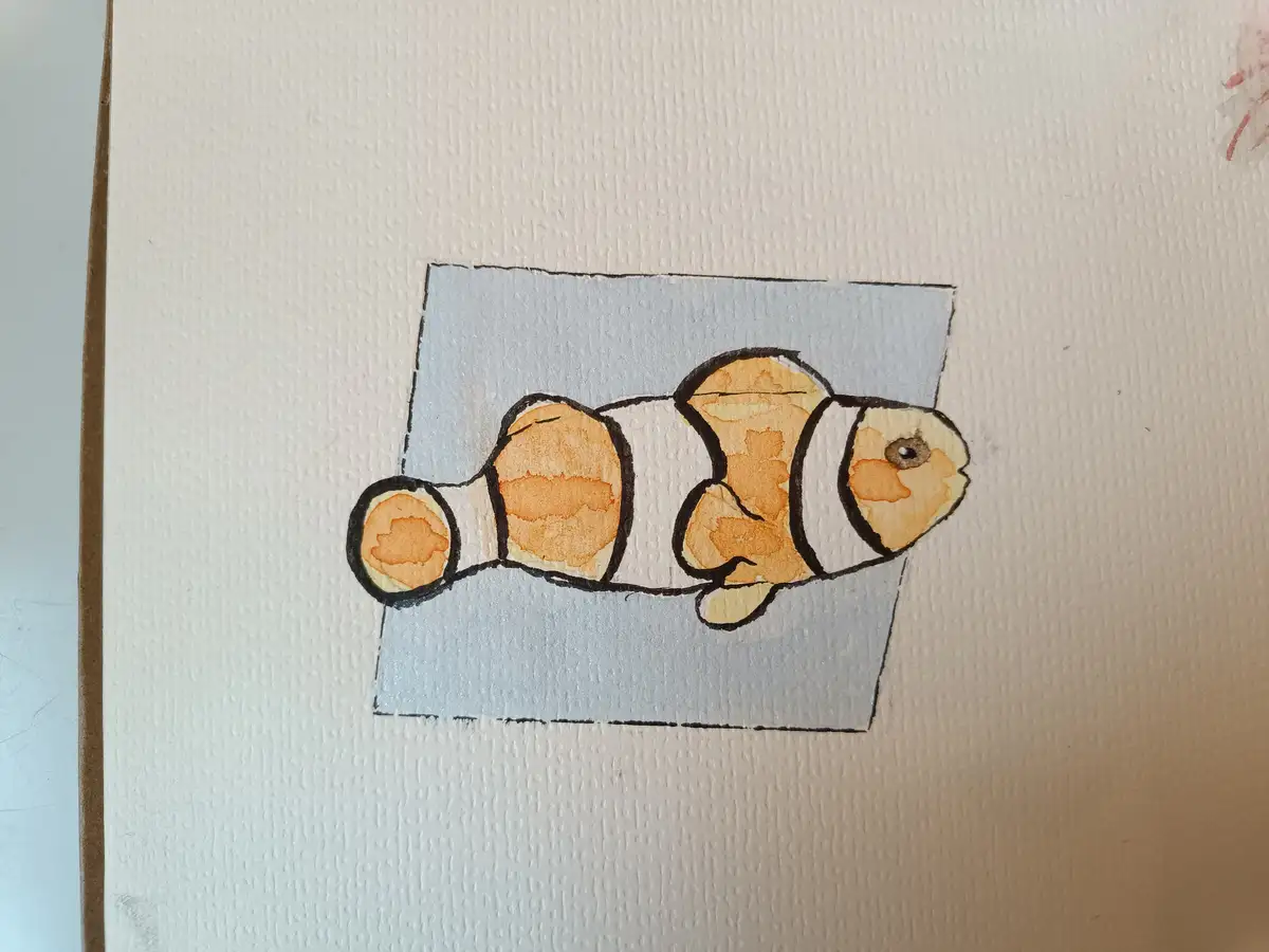 A hand-drawn watercolor painting of a clownfish with orange and white stripes, outlined in black, is depicted swimming…