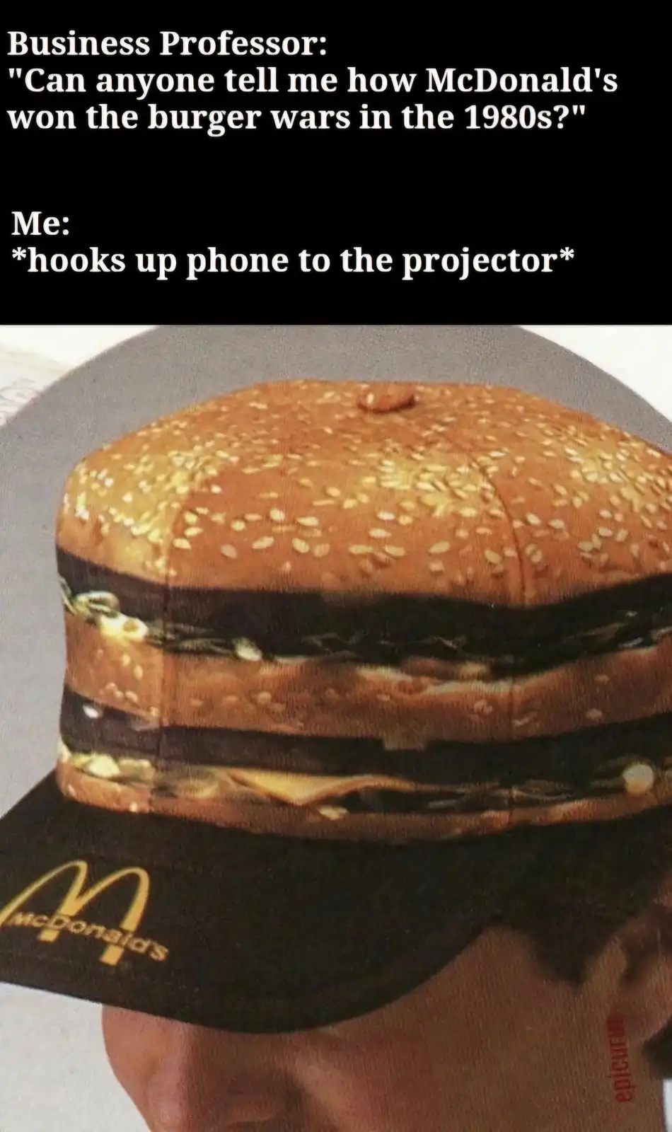 The image shows a large, multi-layered McDonald's burger with sesame seed buns, presented on a black McDonald's branded…