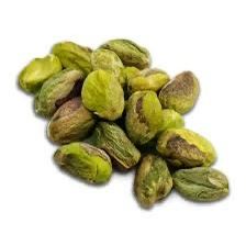 A pile of green, shelled pistachios with their characteristic wrinkled texture and some still partially closed shells, set…