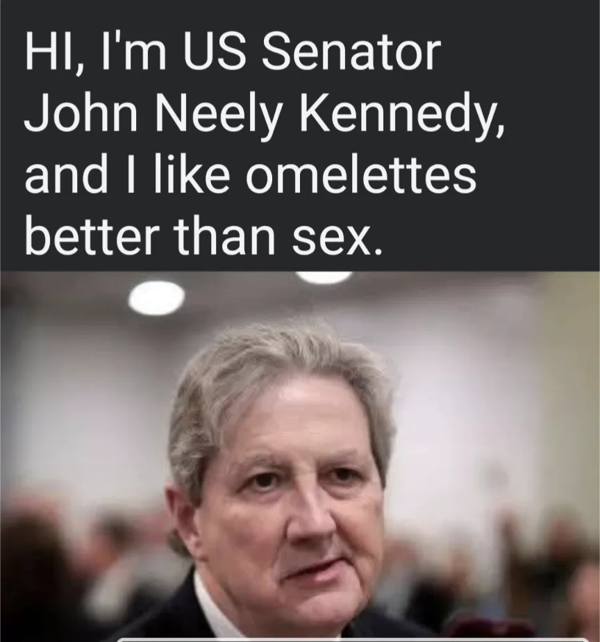 The image shows a close-up of US Senator John Neely Kennedy, a middle-aged man with gray hair wearing a dark suit and white…