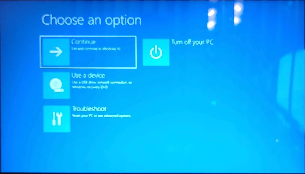 A Windows 10 recovery screen with four options: 'Continue' (highlighted), 'Turn off your PC', 'Use a device', and…