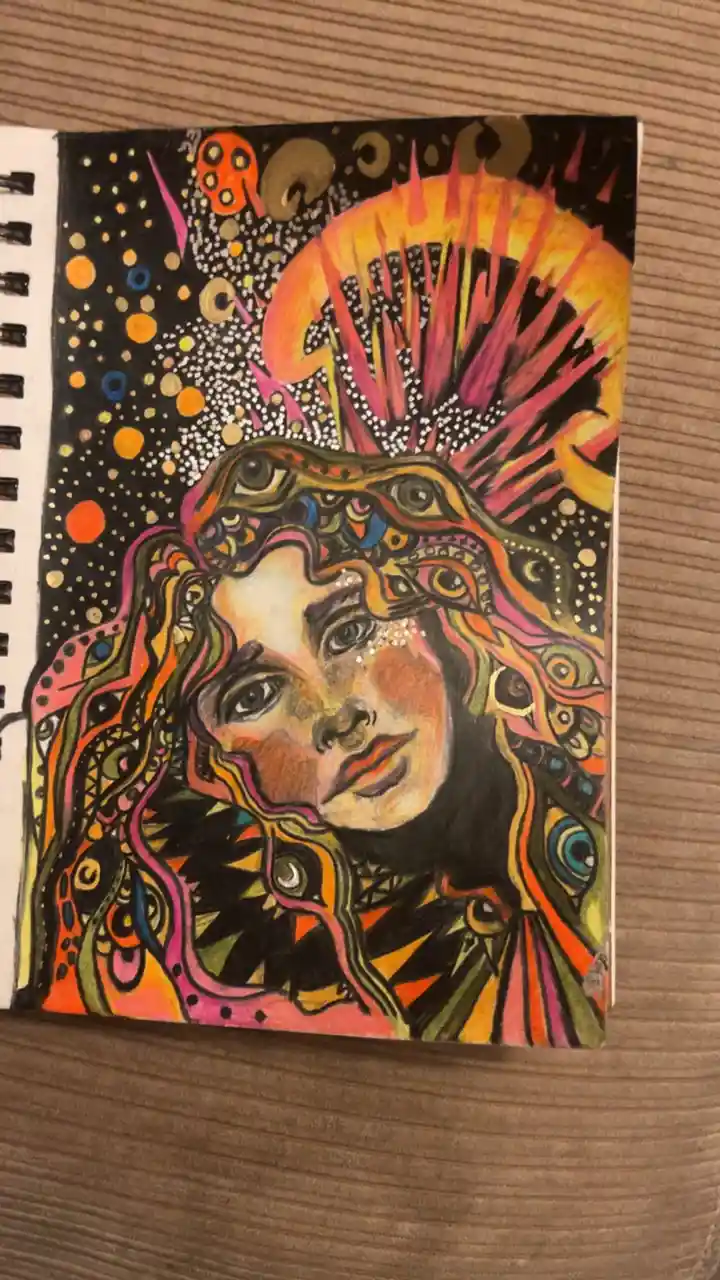 A vibrant, psychedelic drawing in a spiral-bound notebook shows a woman's face surrounded by swirling, colorful patterns…