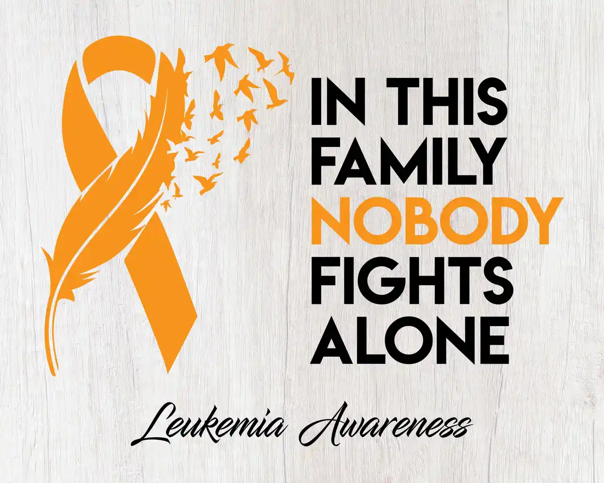 An orange leukemia awareness ribbon with birds flying out of it, set against a light wood background, with the text 'IN THIS…