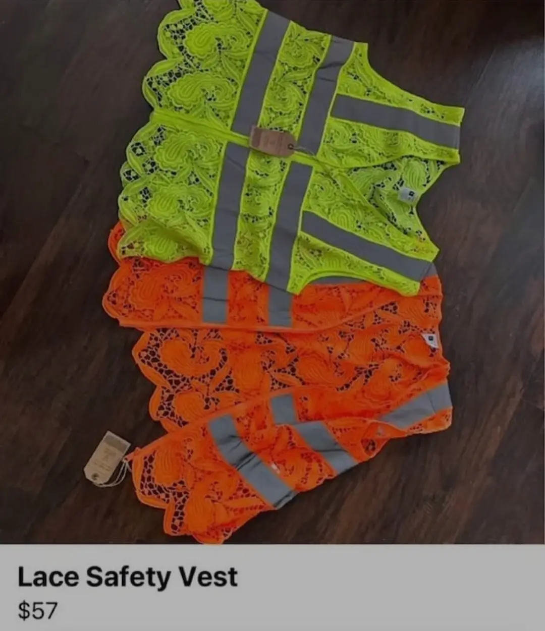 Two safety vests, one neon yellow and one orange, are laid out on a dark wooden floor. Both vests are made of delicate lace…