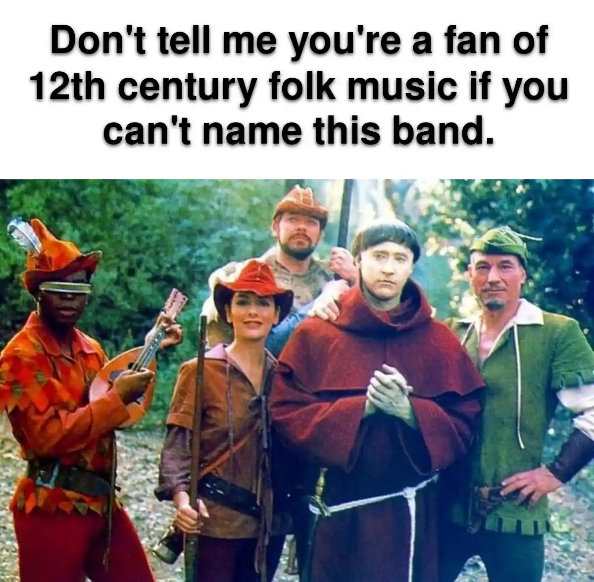 The image shows five people dressed in medieval-style costumes posing outdoors. One person wears a red hooded robe and holds…