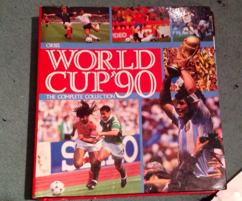 A vintage 'World Cup '90 The Complete Collection' book cover by Orbis, featuring collage photos of soccer players in action…