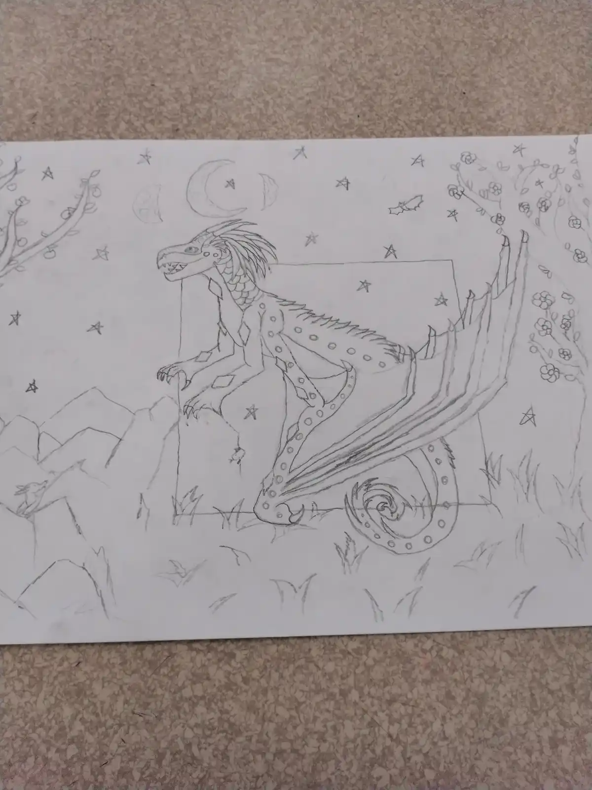 A pencil sketch shows a dragon sitting atop a rectangular block in a nighttime scene with stars, crescent moons, and…