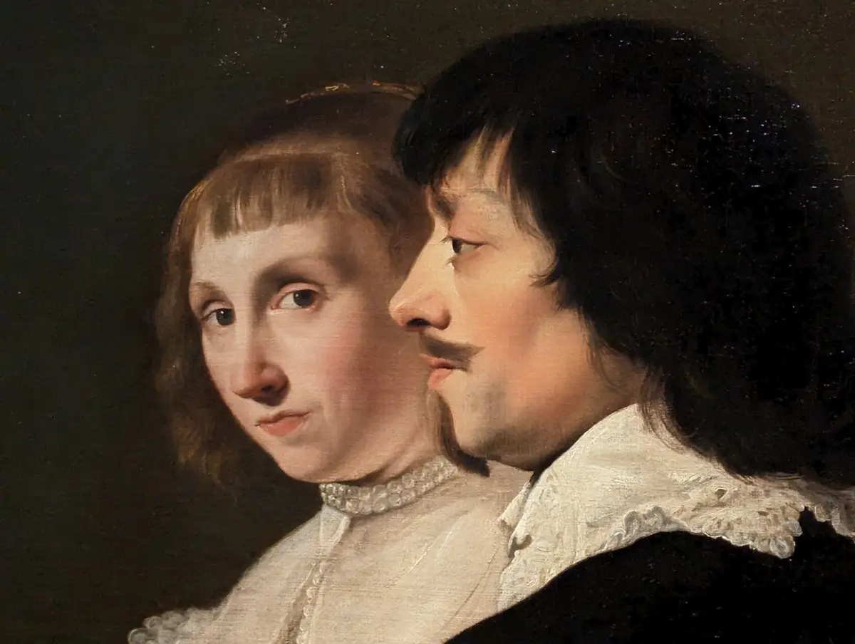 A classical portrait painting shows two people in period clothing, one with dark hair and a mustache looking forward, the…