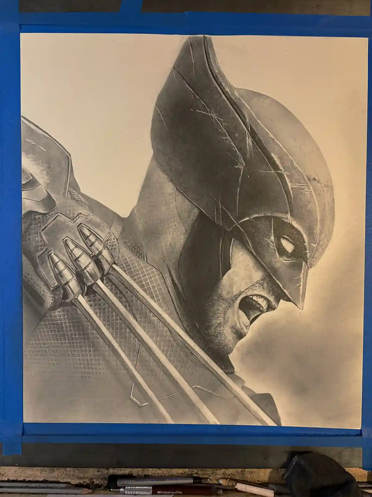 A detailed pencil drawing of a character with Batman's cowl and mask but holding Wolverine's adamantium claws, taped to a…