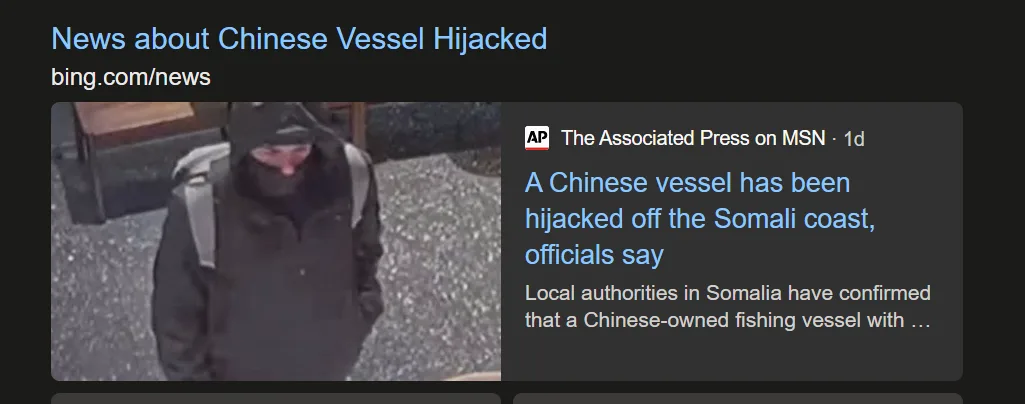 A grainy security camera image shows a person in a dark hooded jacket and backpack, looking down. Overlaid text from a news…