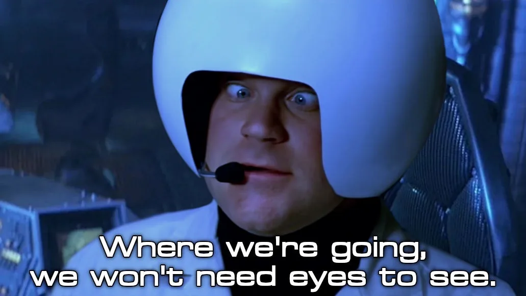 A man in a white helmet with a microphone, eyes wide open, seated in a futuristic cockpit. The overlaid text reads 'Where…