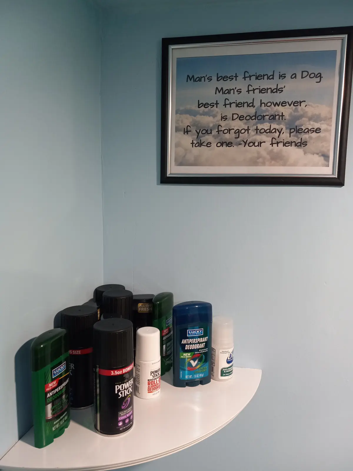 A white shelf in a corner holds multiple deodorant products, including sticks and sprays from brands like Lucky and Power…