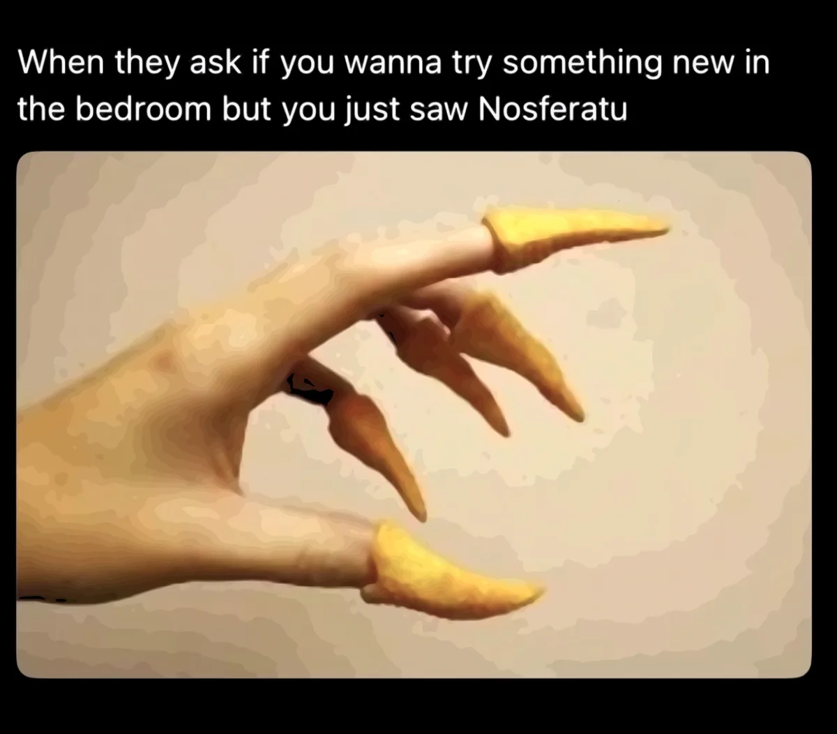 The image shows a stylized, pale hand with long, yellowish, claw-like fingernails, evoking a vampire aesthetic. The overlaid…
