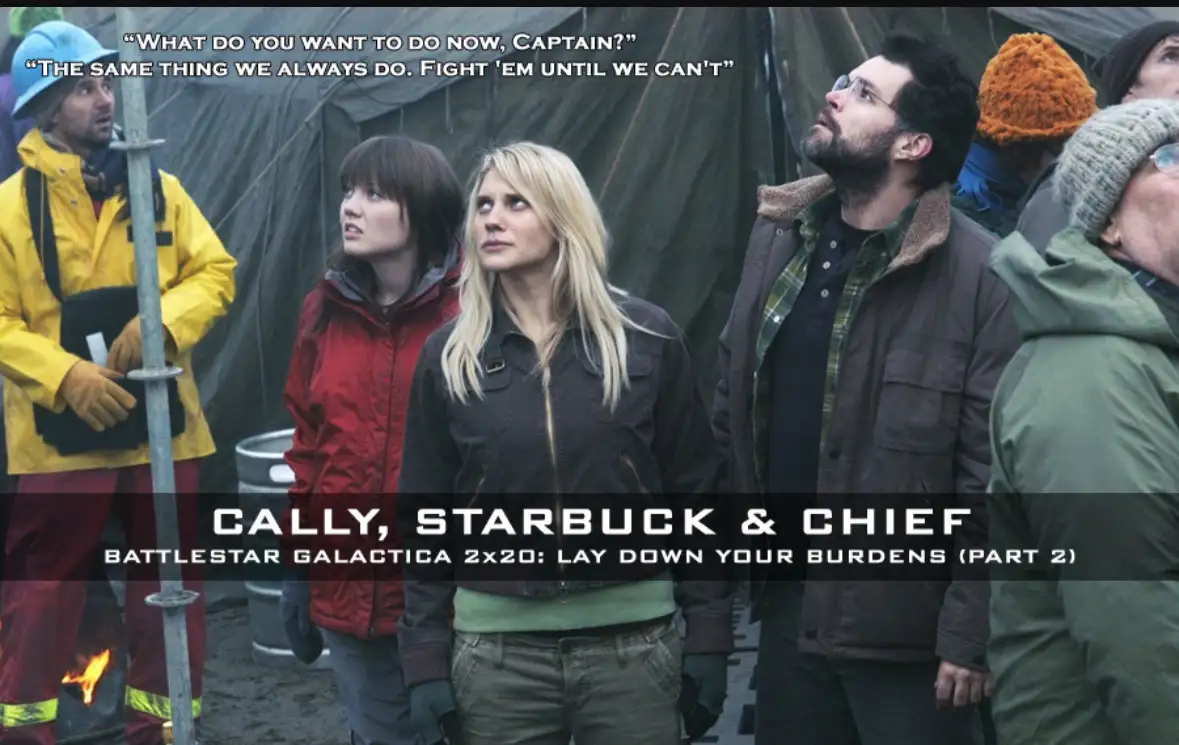 A still from Battlestar Galactica shows characters Cally, Starbuck, and Chief looking upward with serious expressions…