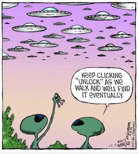 Two green alien figures stand in a field looking up at a sky filled with numerous flying saucers. One alien holds a small…