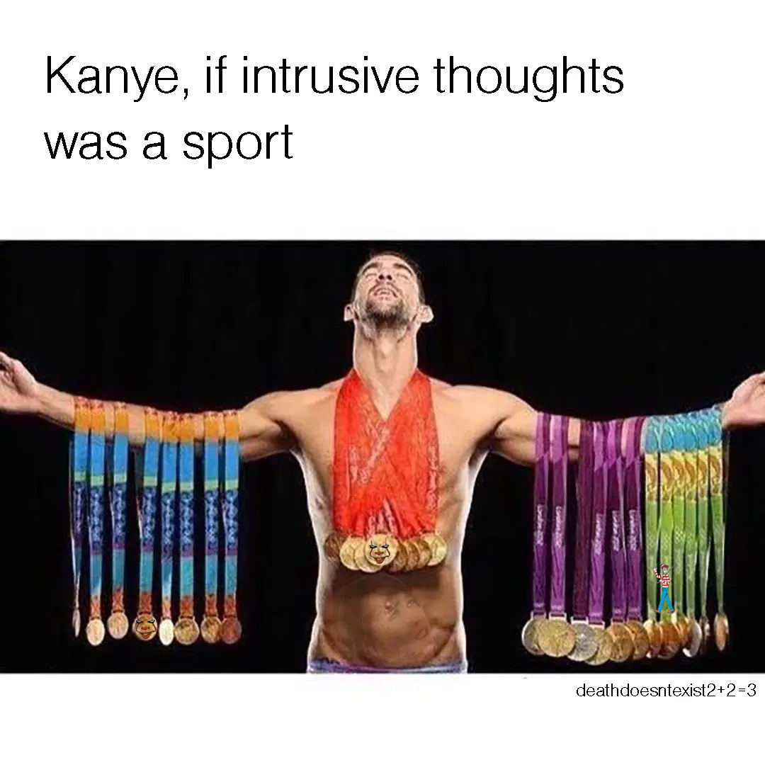 A shirtless man with his arms outstretched, wearing a red sash and numerous Olympic-style medals hanging from his arms and…