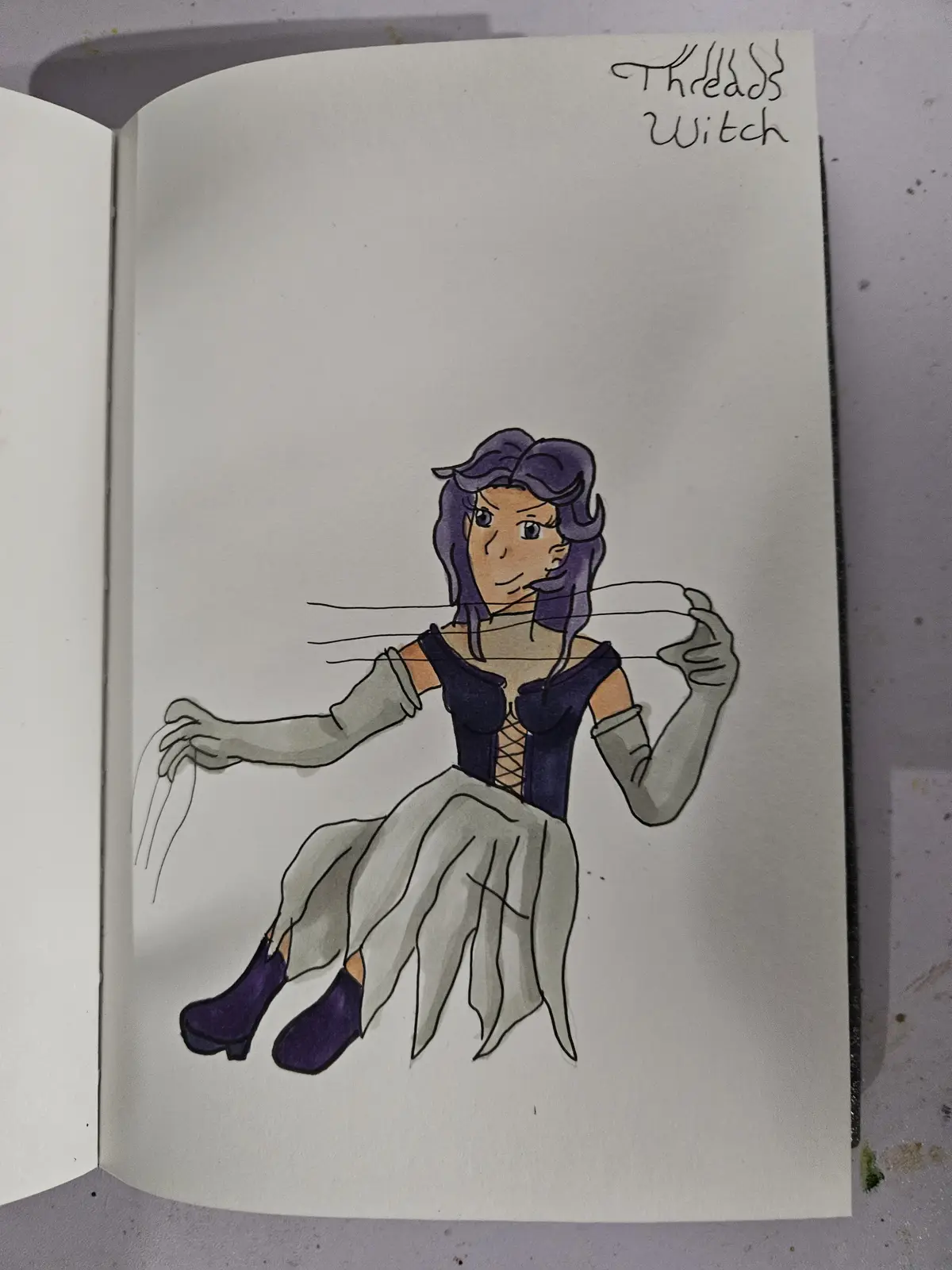 A hand-drawn illustration in a sketchbook shows a woman with purple hair, wearing a dark blue corset and grey skirt, sitting…