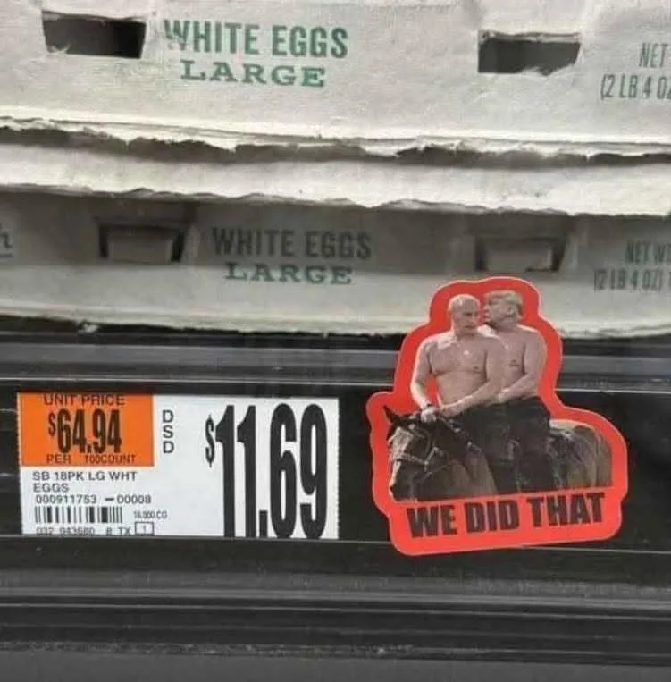 A supermarket shelf displays a carton of white large eggs with a price tag showing $11.69 and a unit price of $64.94 per 100…